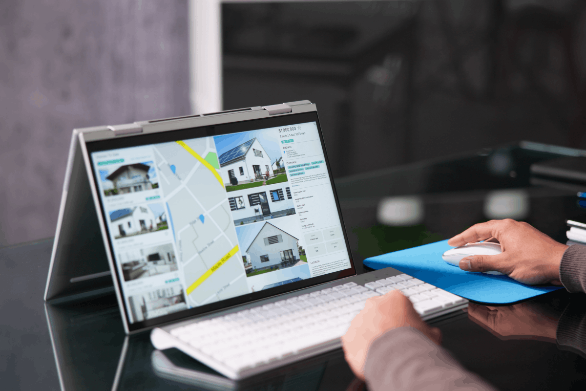 Immobilienportal: Immobilienanzeigen mit Kartenansicht und Hausfotos auf Laptop-Bildschirm